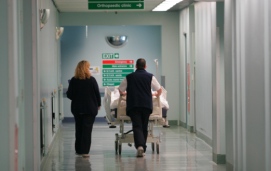 Palmerston North Hospital bed being pushed down a corridor by orderlies